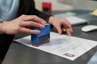 middle-aged-woman-stamping-document-at-visa-center-2026-03-05-11-48-07-utc (1)