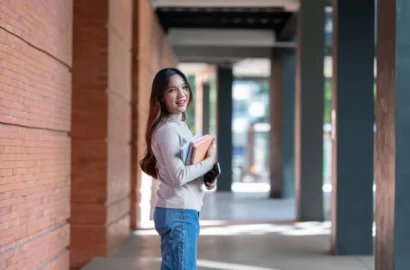 young-asian-woman-student-holding-books-and-smartp-2026-01-08-02-34-41-utc (1)
